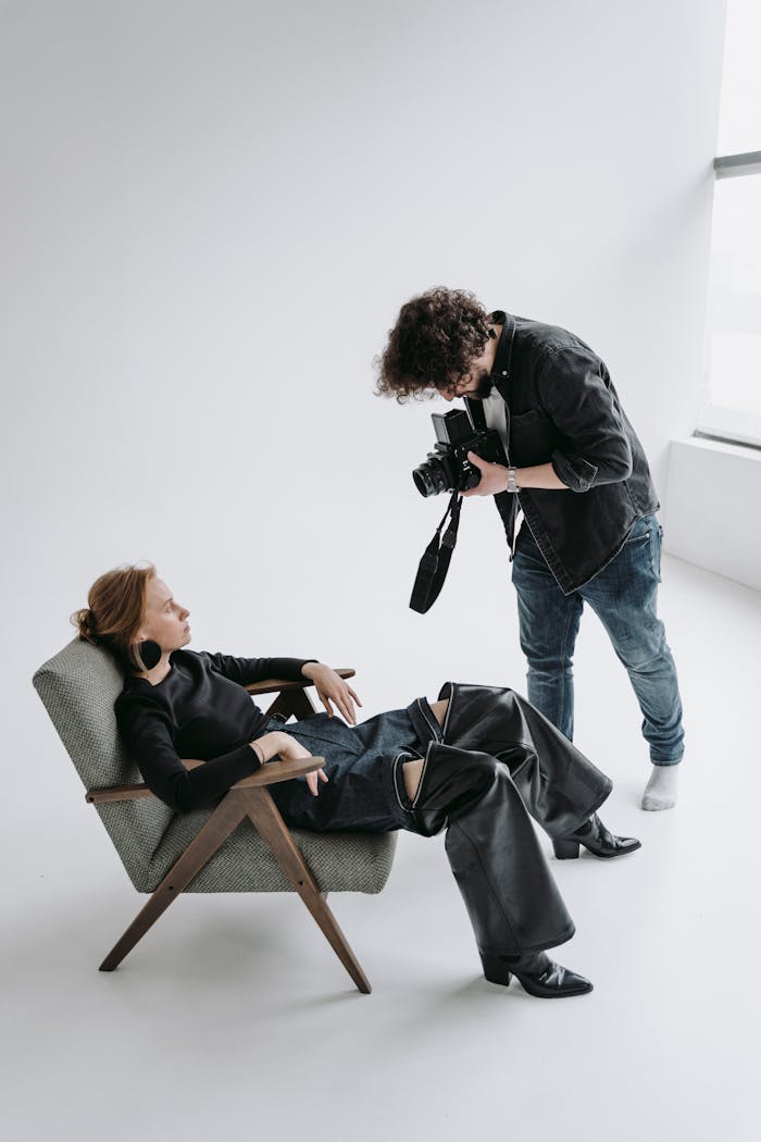 Photographer directing a model in modern studio setting.